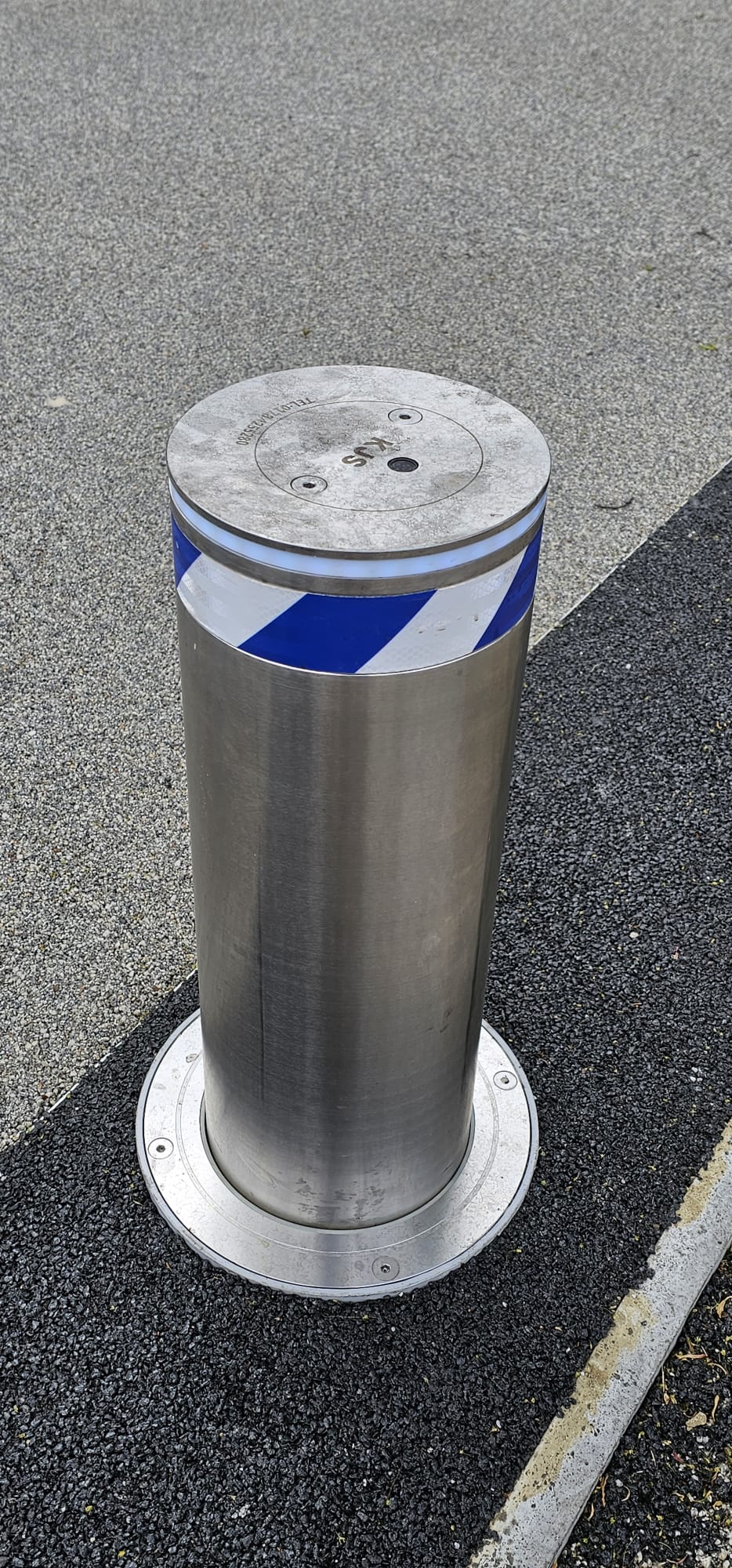 Reflective KJS security bollard in a finished driveway